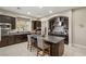 Modern kitchen with dark cabinetry, granite countertops, and stainless steel appliances at 7670 Frittata Ave, Las Vegas, NV 89113