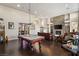 Elegant living room featuring a pool table and dark hardwood floors at 7670 Frittata Ave, Las Vegas, NV 89113