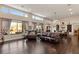 Bright living room with hardwood floors and large windows at 7670 Frittata Ave, Las Vegas, NV 89113