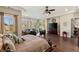 Spacious main bedroom with sitting area, large TV, and hardwood floors at 7670 Frittata Ave, Las Vegas, NV 89113