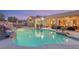 Inviting pool with waterfall feature, surrounded by a patio and lounge area at 7670 Frittata Ave, Las Vegas, NV 89113
