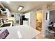 Kitchen with white cabinets, view into bathroom at 7733 Allerton Ave, Las Vegas, NV 89128