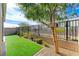Landscaped backyard with artificial turf and a wood fence at 7745 Rosebark Cliffs St, North Las Vegas, NV 89084