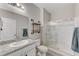 Clean bathroom with granite countertop, large shower and industrial shelving at 7745 Rosebark Cliffs St, North Las Vegas, NV 89084