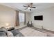Serene bedroom with gray couch and carpet flooring at 7745 Rosebark Cliffs St, North Las Vegas, NV 89084