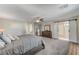 Large bedroom with barn doors leading to the bathroom at 7745 Rosebark Cliffs St, North Las Vegas, NV 89084