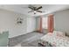 Bright bedroom with ceiling fan, window coverings, and neutral-toned carpet at 7745 Rosebark Cliffs St, North Las Vegas, NV 89084