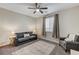 Bright bedroom with gray couch and carpet flooring at 7745 Rosebark Cliffs St, North Las Vegas, NV 89084