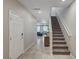 Bright entryway with staircase and view into living room at 7745 Rosebark Cliffs St, North Las Vegas, NV 89084