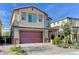 Two-story home with attached garage and landscaping at 7745 Rosebark Cliffs St, North Las Vegas, NV 89084