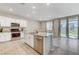 Open concept kitchen with island, stainless steel appliances, and granite countertops at 7745 Rosebark Cliffs St, North Las Vegas, NV 89084