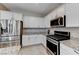 Modern kitchen with stainless steel appliances and granite countertops at 7745 Rosebark Cliffs St, North Las Vegas, NV 89084