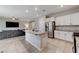 Open concept kitchen with island and stainless steel appliances at 7745 Rosebark Cliffs St, North Las Vegas, NV 89084