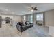 Living room with gray couch and large TV. Access to backyard at 7745 Rosebark Cliffs St, North Las Vegas, NV 89084
