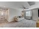 Spacious loft area with plush seating and ceiling fan at 7745 Rosebark Cliffs St, North Las Vegas, NV 89084