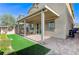 Backyard patio with covered seating and artificial turf at 7745 Rosebark Cliffs St, North Las Vegas, NV 89084