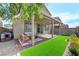 Patio with covered seating area and artificial turf at 7745 Rosebark Cliffs St, North Las Vegas, NV 89084