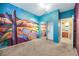 Bedroom with colorful wall mural, mirrored closet, and access to bathroom at 8482 Lambert Dr, Las Vegas, NV 89147