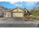 Single-story house with two-car garage and landscaped front yard at 8482 Lambert Dr, Las Vegas, NV 89147