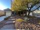 House with a landscaped yard, brick walkway, and two-car garage at 8505 Spotted Fawn Ct, Las Vegas, NV 89131