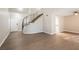 Living room with hardwood floors and curved staircase at 950 Clipper Dr, Henderson, NV 89015