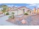 Single-story house with a landscaped front yard and a two-car garage at 9709 Peacock Hill Cir, Las Vegas, NV 89117