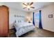 Cozy bedroom with ceiling fan, window, and carpet flooring at 10581 Olinda St, Las Vegas, NV 89179