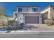 Two-story house with attached garage and landscaped front yard at 10581 Olinda St, Las Vegas, NV 89179