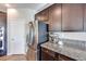 Kitchen with stainless steel refrigerator and granite countertops at 10581 Olinda St, Las Vegas, NV 89179