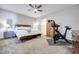 Main bedroom with king bed, Peloton bike, and wood dresser at 10581 Olinda St, Las Vegas, NV 89179