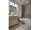 Bathroom with a bathtub, toilet, and vanity with modern fixtures at 11751 Emerald Lake Ave, Las Vegas, NV 89138