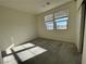 Bright bedroom with neutral walls and carpet, featuring multiple windows at 11751 Emerald Lake Ave, Las Vegas, NV 89138