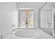 Bathroom with large bathtub and window at 1230 Bruce St, Pahrump, NV 89048