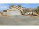 Attached garage with white door and landscaping at 1230 Bruce St, Pahrump, NV 89048