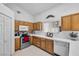 Well-equipped kitchen featuring wood cabinets and appliances at 1230 Bruce St, Pahrump, NV 89048