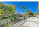 Private deck overlooking backyard with lush landscaping and mountain views at 1259 Moon Vision St, Henderson, NV 89052