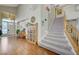 Grand entryway with hardwood floors, staircase, and a charming bookshelf at 1259 Moon Vision St, Henderson, NV 89052