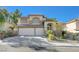 Two-story house with a three-car garage and desert landscaping at 1259 Moon Vision St, Henderson, NV 89052