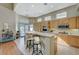 Spacious kitchen with island, stainless steel appliances, and light wood cabinets at 1259 Moon Vision St, Henderson, NV 89052