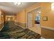 Long hallway with carpet and doors to rooms at 145 E Harmon Ave # 2215, Las Vegas, NV 89109