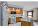 Kitchen with white appliances and wood cabinets at 1518 Jenny Linn Dr # 105, Henderson, NV 89014