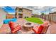 Landscaped backyard with fire pit and seating area at 1556 Bryce Canyon St, Boulder City, NV 89005