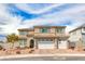 Two-story house with three-car garage, landscaping, and brick driveway at 1556 Bryce Canyon St, Boulder City, NV 89005