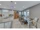 Open kitchen with white cabinets, island, and dining area at 1556 Bryce Canyon St, Boulder City, NV 89005