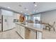 Well-appointed kitchen features a large island, white cabinetry, and stainless steel appliances at 1556 Bryce Canyon St, Boulder City, NV 89005