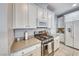 Modern kitchen with white cabinets, stainless steel appliances, and neutral countertops at 1556 Bryce Canyon St, Boulder City, NV 89005