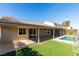 Home exterior showcasing a covered patio, pool, and landscaped yard at 160 Swale Ln, Las Vegas, NV 89144