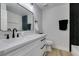 Modern bathroom with white vanity and black herringbone tile at 160 Swale Ln, Las Vegas, NV 89144