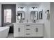 Elegant bathroom with double vanity, modern fixtures, and a soaking tub at 160 Swale Ln, Las Vegas, NV 89144