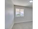 Bright bedroom with grey carpet and a window at 160 Swale Ln, Las Vegas, NV 89144